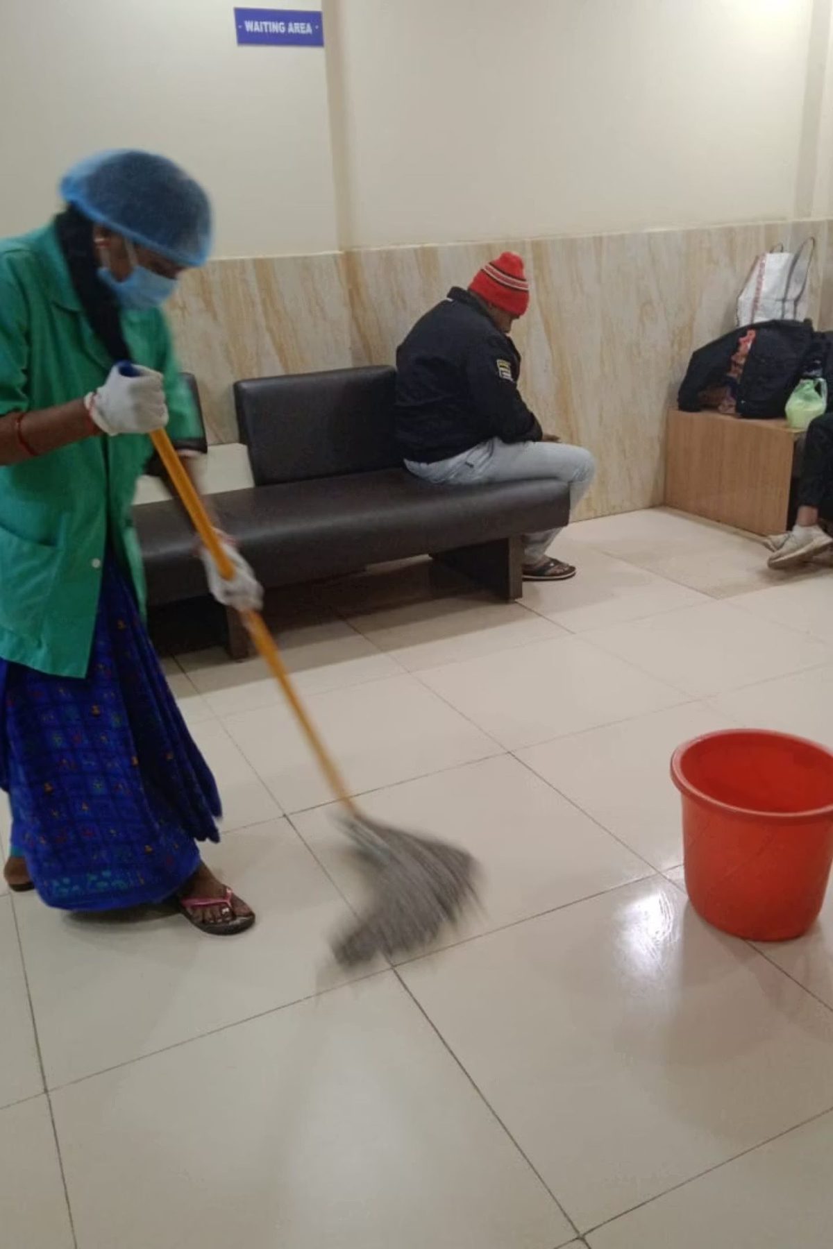 Housekeeping staff cleaning the hospital waiting area
